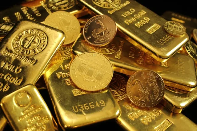 Gold coins and bars representing traditional gold weight units.